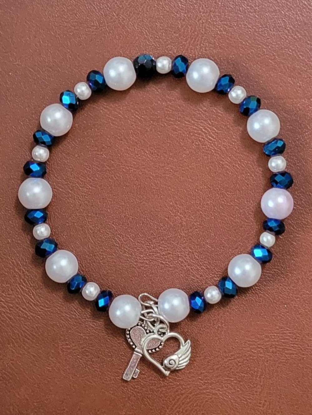 Sparkling Blue Beads with White and Gold Heart Accents with Silver Charms